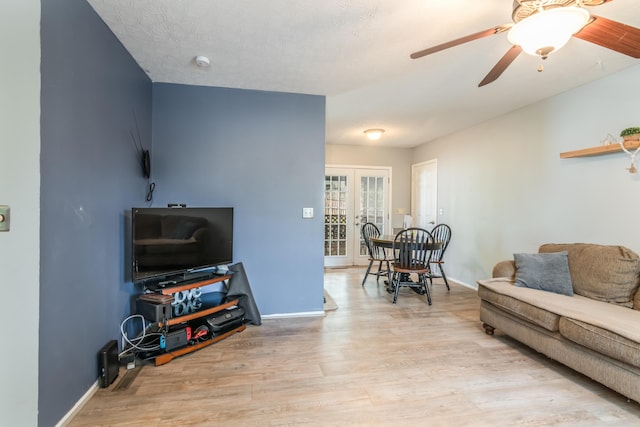 211 Spring Meadows Pkwy, Branson, MO 65616 - living area featuring light wood-style floors, french doors, baseboards, and a ceiling fan