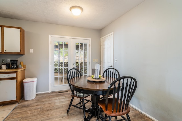 211 Spring Meadows Pkwy, Branson, MO 65616 - dining area with french doors, light wood-style floors, and baseboards