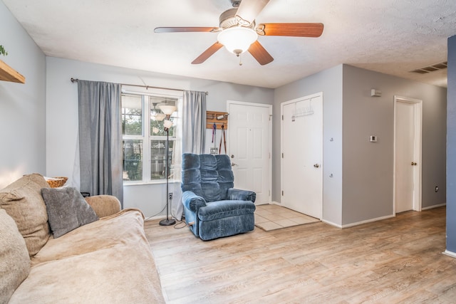 211 Spring Meadows Pkwy, Branson, MO 65616 - living area featuring wood finished floors, a ceiling fan, and baseboards