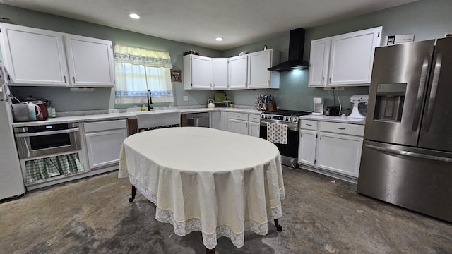 8689 County Road 7110, West Plains, MO 65775 - kitchen featuring stainless steel appliances, wall chimney range hood, a sink, white cabinetry, and recessed lighting