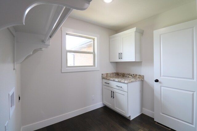 3419 S Suburban Ave, Springfield, MO 65807 - washroom featuring cabinet space, baseboards, and dark wood-style flooring