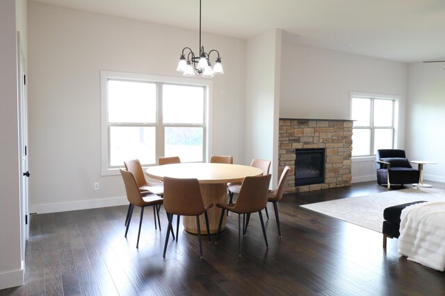3419 S Suburban Ave, Springfield, MO 65807 - dining room featuring a fireplace, a chandelier, baseboards, and dark wood-style flooring