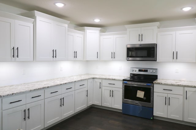 3419 S Suburban Ave, Springfield, MO 65807 - kitchen with stainless steel appliances, white cabinetry, dark wood-type flooring, recessed lighting, and light stone counters