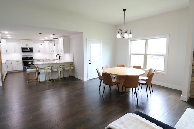3419 S Suburban Ave, Springfield, MO 65807 - dining space featuring baseboards, dark wood-style floors, and a chandelier