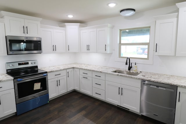 3419 S Suburban Ave, Springfield, MO 65807 - kitchen featuring appliances with stainless steel finishes, a sink, dark wood-style floors, white cabinetry, and recessed lighting