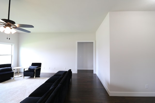 3419 S Suburban Ave, Springfield, MO 65807 - living room featuring baseboards, ceiling fan, and dark wood-type flooring