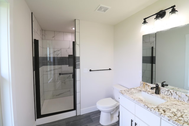 3419 S Suburban Ave, Springfield, MO 65807 - full bath with vanity, toilet, a stall shower, and wood finished floors