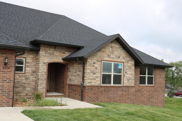3419 S Suburban Ave, Springfield, MO 65807 - view of front of property with stone siding, roof with shingles, and a front lawn