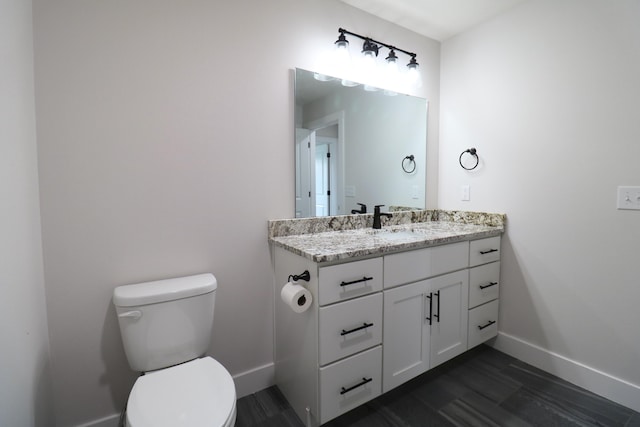 3419 S Suburban Ave, Springfield, MO 65807 - bathroom with baseboards, toilet, vanity, and wood finished floors
