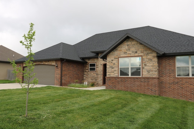 3419 S Suburban Ave, Springfield, MO 65807 - view of front of house with a shingled roof, stone siding, an attached garage, and driveway