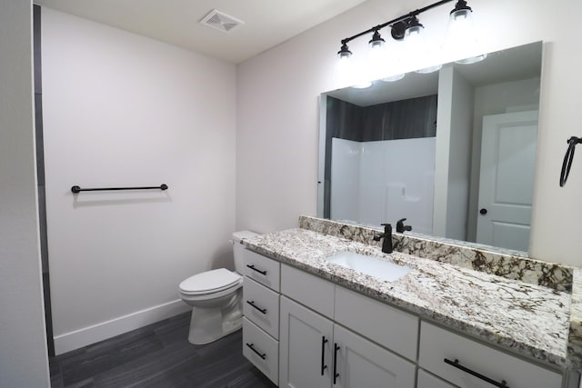 3419 S Suburban Ave, Springfield, MO 65807 - bathroom featuring wood finished floors, baseboards, vanity, toilet, and a shower