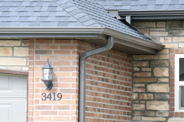 3419 S Suburban Ave, Springfield, MO 65807 - exterior view of brick siding, gutters, a downspout, and roof with shingles