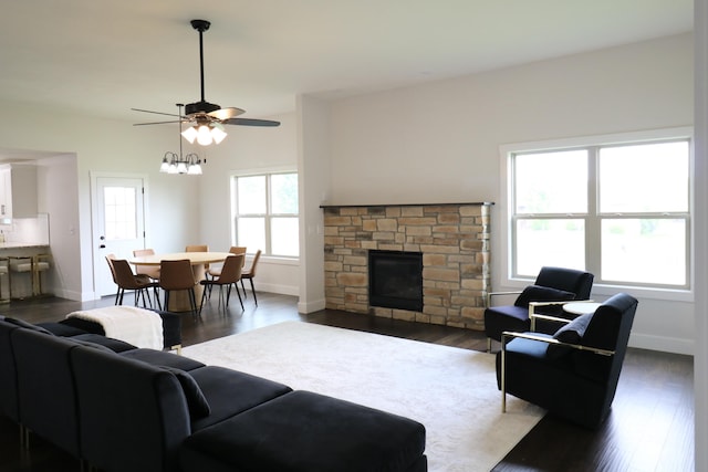 3419 S Suburban Ave, Springfield, MO 65807 - living area featuring baseboards, a fireplace, a ceiling fan, and dark wood-type flooring