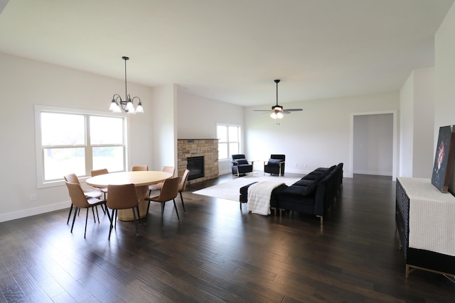3419 S Suburban Ave, Springfield, MO 65807 - dining space featuring a stone fireplace, dark wood finished floors, ceiling fan, baseboards, and a chandelier