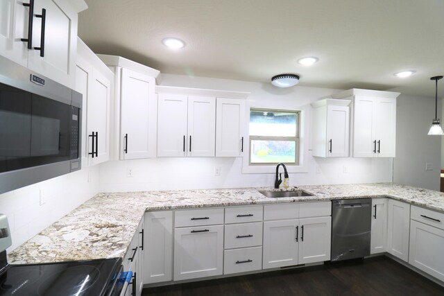 3419 S Suburban Ave, Springfield, MO 65807 - kitchen featuring a sink, stainless steel appliances, white cabinets, dark wood-type flooring, and light stone countertops