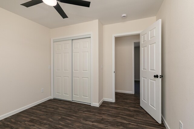 281 N 2nd St, Verona, MO 65769 - unfurnished bedroom featuring dark wood-type flooring, baseboards, a closet, and ceiling fan