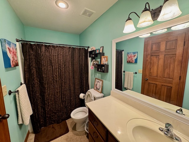 1054 W Itaska Rd, Nixa, MO 65714 - bathroom featuring toilet, vanity, tile patterned floors, curtained shower, and a textured ceiling