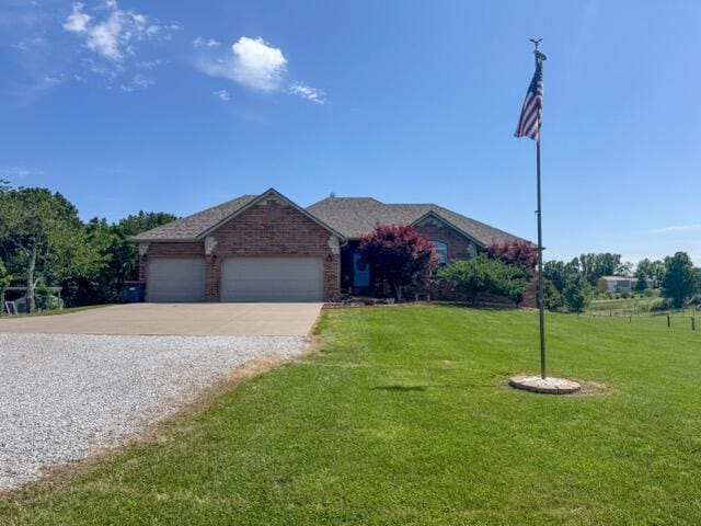 1054 W Itaska Rd, Nixa, MO 65714 - ranch-style home featuring concrete driveway, a front yard, and a garage