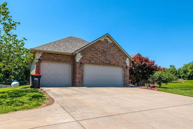 1054 W Itaska Rd, Nixa, MO 65714 - view of front of property featuring an attached garage, brick siding, driveway, and roof with shingles