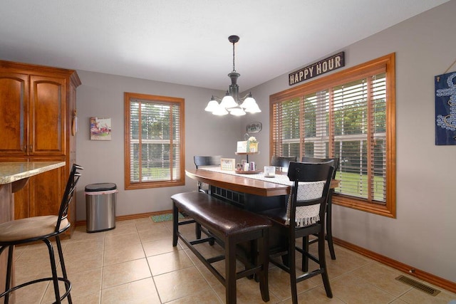 1054 W Itaska Rd, Nixa, MO 65714 - dining space with a chandelier and light tile patterned flooring