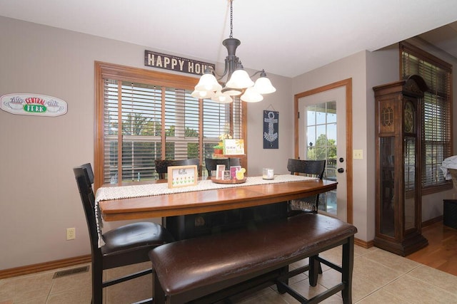 1054 W Itaska Rd, Nixa, MO 65714 - dining room featuring a chandelier and light tile patterned floors
