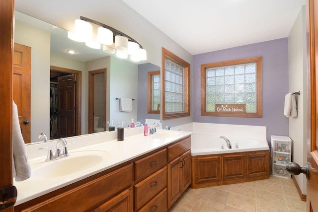 1054 W Itaska Rd, Nixa, MO 65714 - bathroom with double vanity, a garden tub, and tile patterned floors