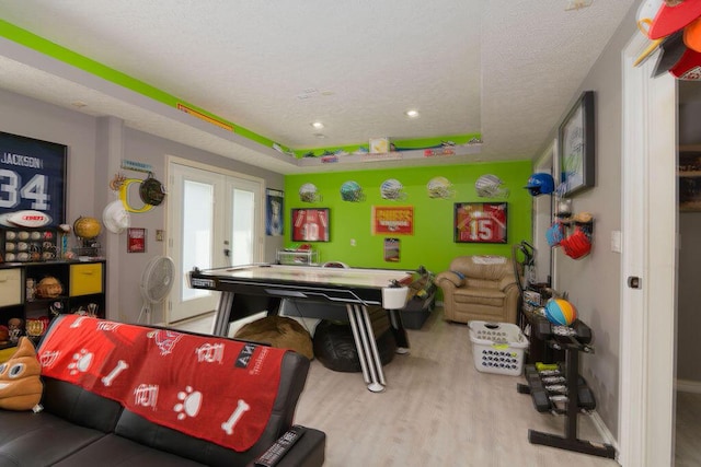 1054 W Itaska Rd, Nixa, MO 65714 - recreation room featuring french doors, wood finished floors, a textured ceiling, and a raised ceiling