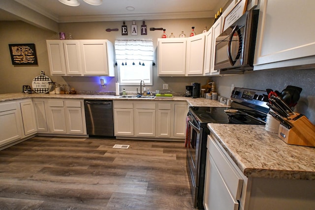 511 C St, Deepwater, MO 64740 - kitchen with electric range, black microwave, dishwasher, a sink, and ornamental molding