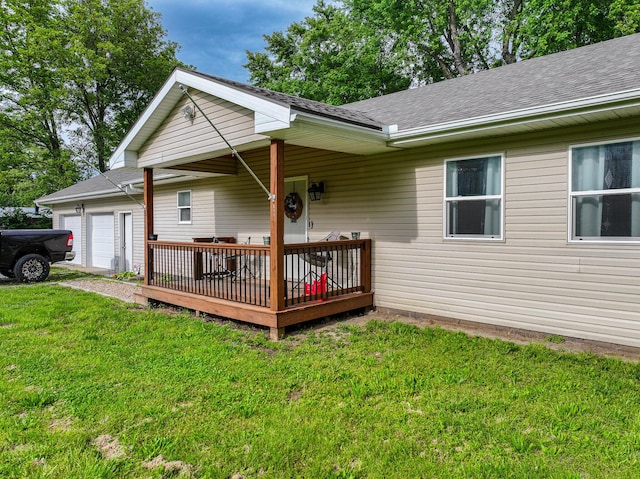 511 C St, Deepwater, MO 64740 - view of front of house featuring a shingled roof, a front yard, a deck, and a garage