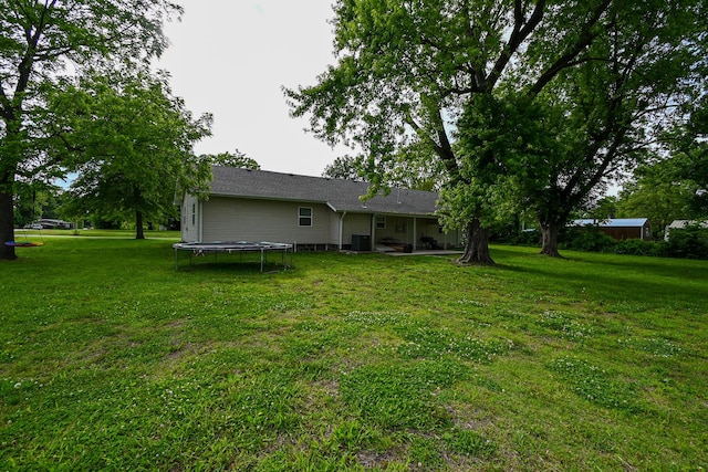 511 C St, Deepwater, MO 64740 - rear view of house with a trampoline, a lawn, a patio area, and cooling unit