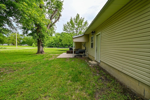 511 C St, Deepwater, MO 64740 - view of green lawn featuring a patio area and an outdoor hangout area