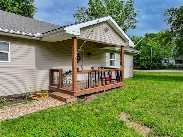 511 C St, Deepwater, MO 64740 - view of front of property featuring a front lawn, roof with shingles, and a deck