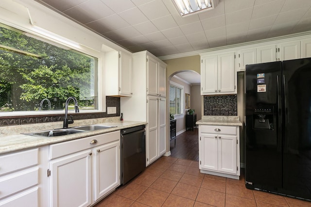 1104 E Buffalo St, Bolivar, MO 65613 - kitchen featuring black appliances, a sink, arched walkways, white cabinets, and tile patterned floors
