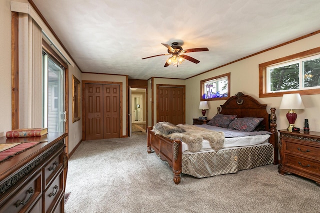 1104 E Buffalo St, Bolivar, MO 65613 - bedroom with light colored carpet, two closets, ornamental molding, and a ceiling fan