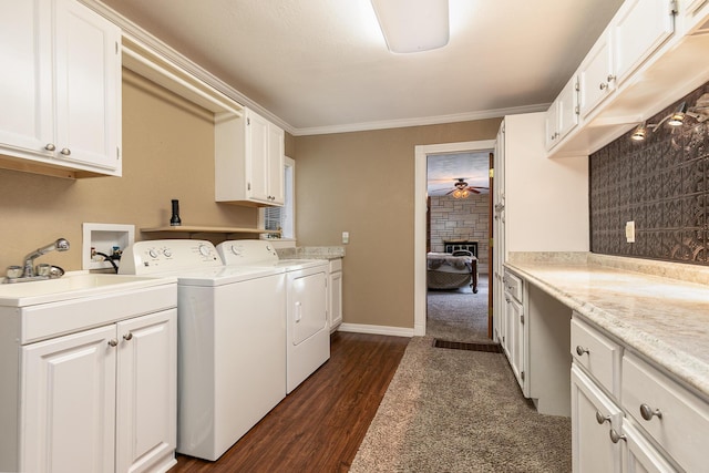 1104 E Buffalo St, Bolivar, MO 65613 - laundry room featuring cabinet space, washing machine and dryer, a ceiling fan, dark wood finished floors, and a fireplace