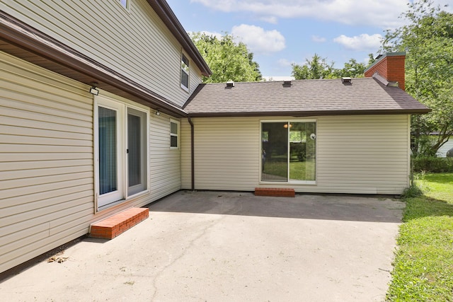 1104 E Buffalo St, Bolivar, MO 65613 - back of house with a patio, a shingled roof, and a chimney