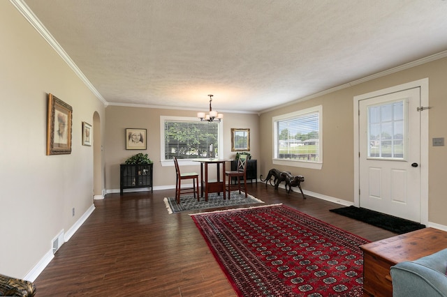 1104 E Buffalo St, Bolivar, MO 65613 - dining space featuring wood finished floors, a chandelier, crown molding, arched walkways, and baseboards