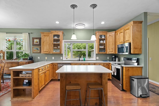 36205 State Highway 413, Crane, MO 65633 - kitchen featuring stainless steel appliances, light wood finished floors, a kitchen island, and recessed lighting