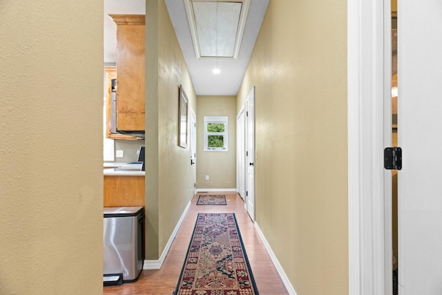 36205 State Highway 413, Crane, MO 65633 - corridor with attic access, wood finished floors, a textured wall, and baseboards