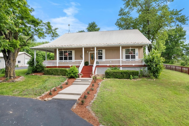 36205 State Highway 413, Crane, MO 65633 - view of front of house featuring a porch, metal roof, and stairway