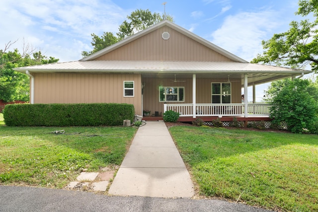 36205 State Highway 413, Crane, MO 65633 - farmhouse-style home featuring a porch, a front yard, and metal roof