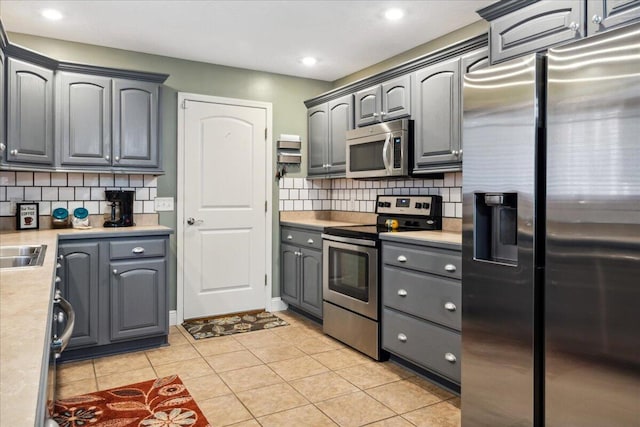 1270 E Ogorman Ct, Springfield, MO 65803 - kitchen featuring stainless steel appliances, light countertops, gray cabinetry, tasteful backsplash, and recessed lighting