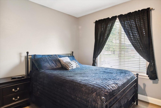 1270 E Ogorman Ct, Springfield, MO 65803 - bedroom featuring multiple windows, baseboards, and wood finished floors