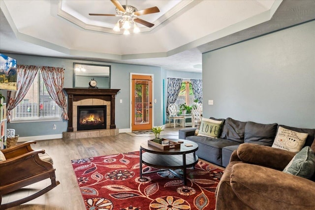 1270 E Ogorman Ct, Springfield, MO 65803 - living room with a tray ceiling, ceiling fan, a fireplace, wood finished floors, and baseboards