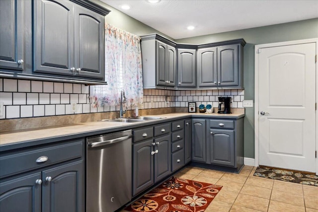 1270 E Ogorman Ct, Springfield, MO 65803 - kitchen featuring stainless steel dishwasher, a sink, decorative backsplash, light tile patterned floors, and gray cabinets