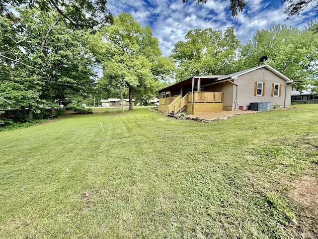 8030 Indiana Dr, Houston, MO 65483 - view of grassy yard featuring a deck and cooling unit