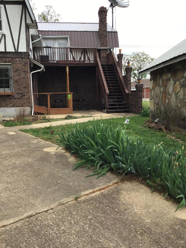 310 S 6th St, Thayer, MO 65791 - back of house featuring brick siding, stairs, and a chimney