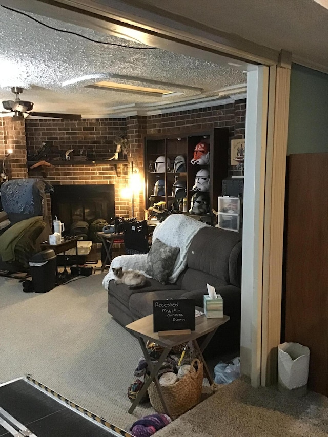 310 S 6th St, Thayer, MO 65791 - below grade area featuring carpet floors, brick wall, a fireplace, and a textured ceiling