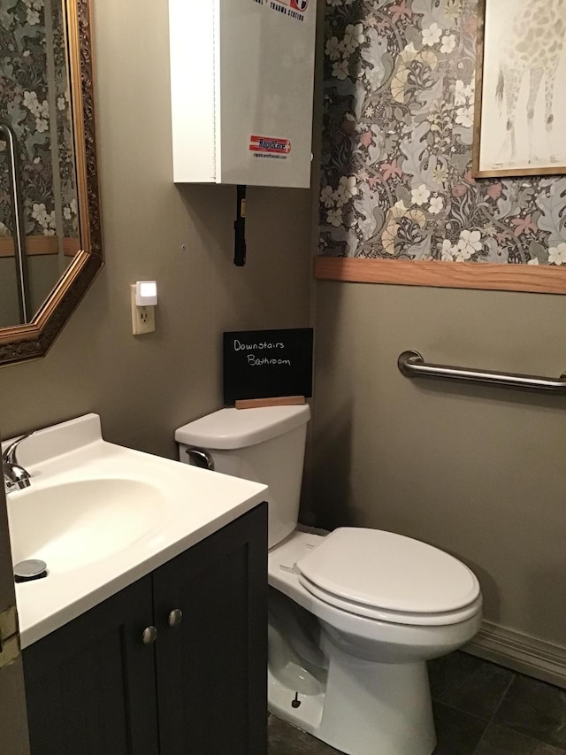 310 S 6th St, Thayer, MO 65791 - bathroom featuring vanity, toilet, tile patterned flooring, and tankless water heater