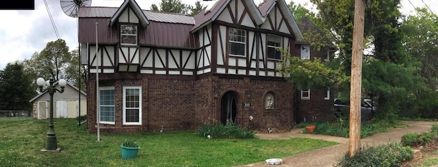 310 S 6th St, Thayer, MO 65791 - english style home featuring brick siding and a front lawn